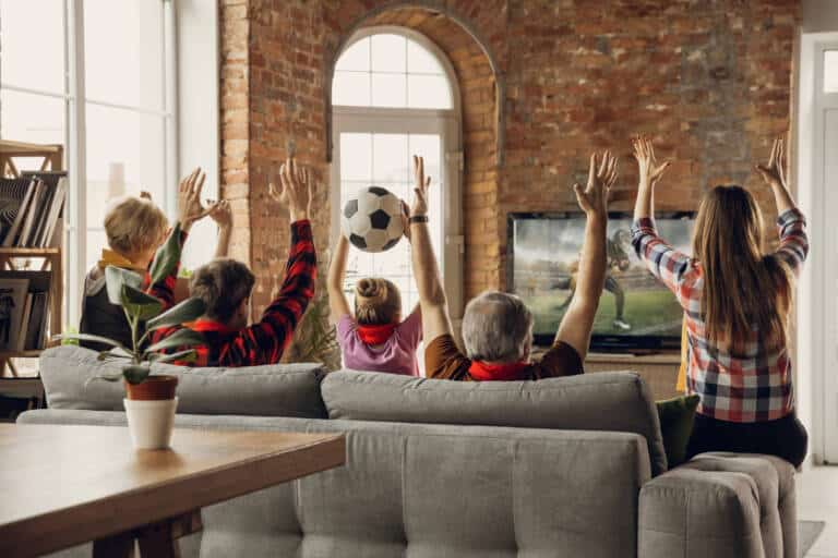 excited happy big family team watch sport match together couch home